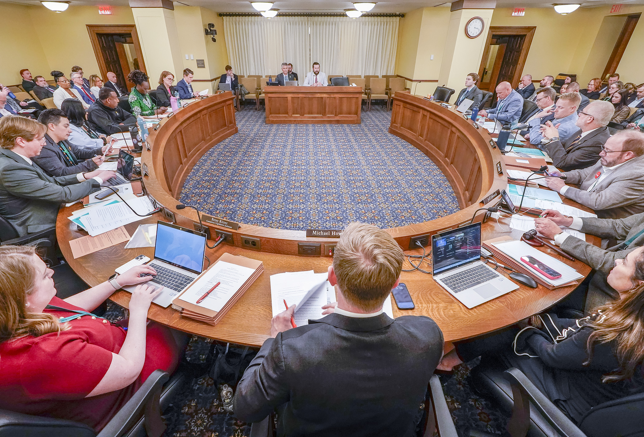 Members of the House Housing Finance and Policy Committee listen as Rep. Spencer Igo and Rep. Larry Kraft describe HF3895, a bill that would limit the zoning authority of local governments over certain housing types. (Photo by Andrew VonBank)